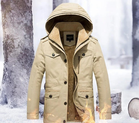 Beige winter coat with hood on a snowy background