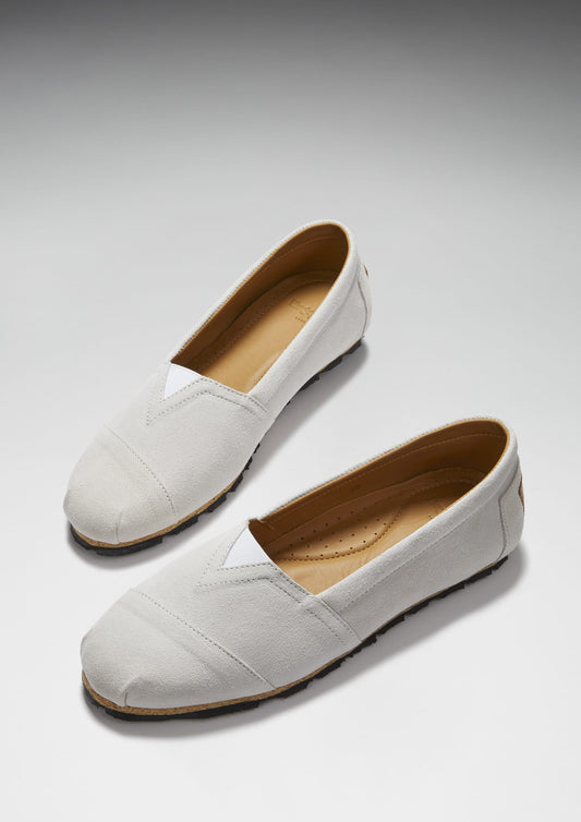 Pair of light gray loafers on a white background