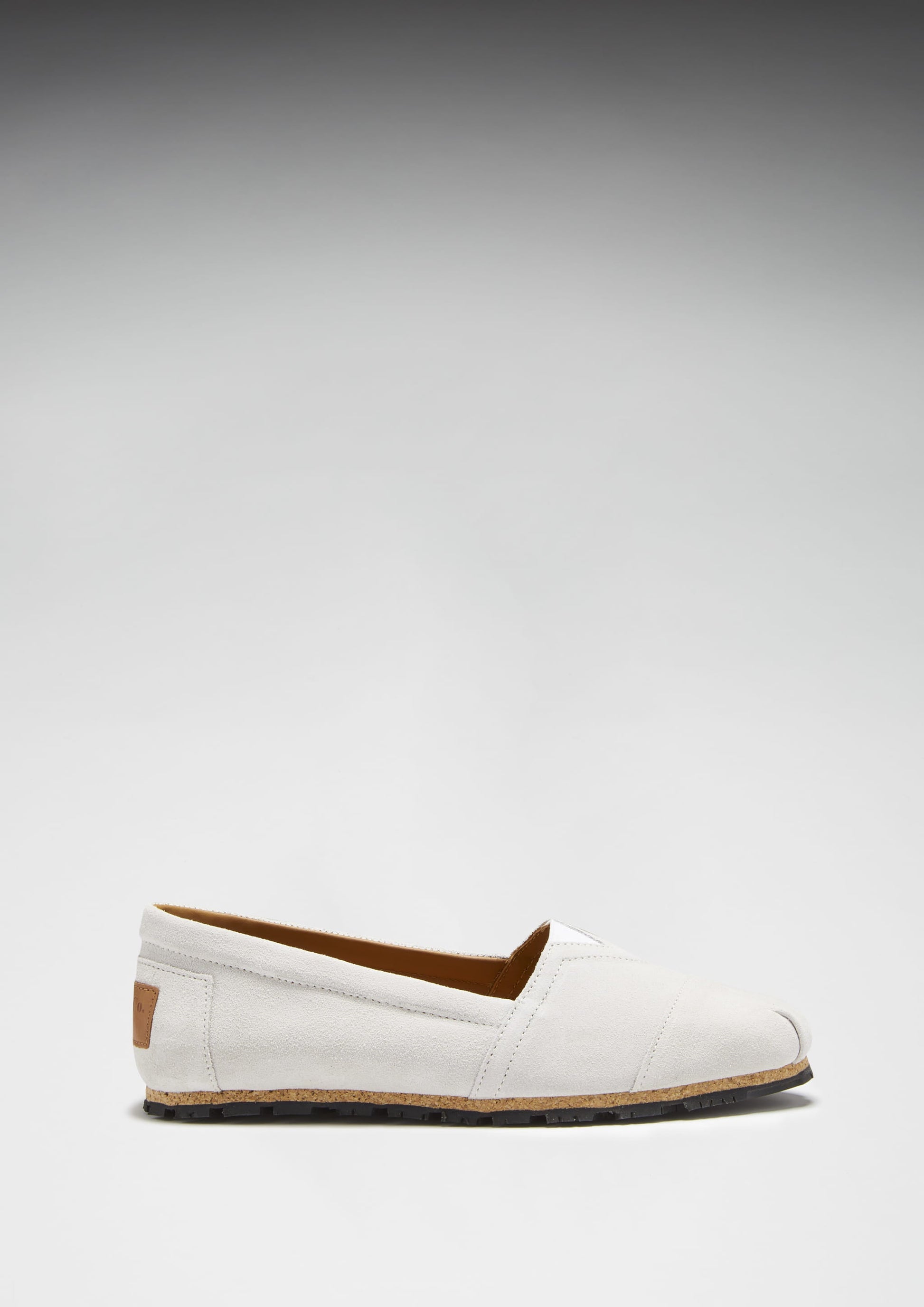 White loafer shoe on a light gray background