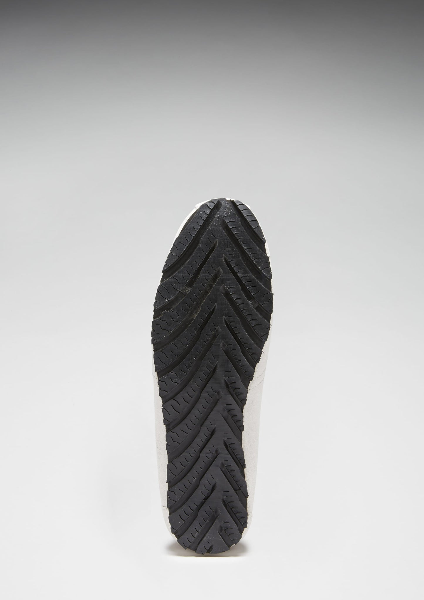 Black shoe sole on a light gray background