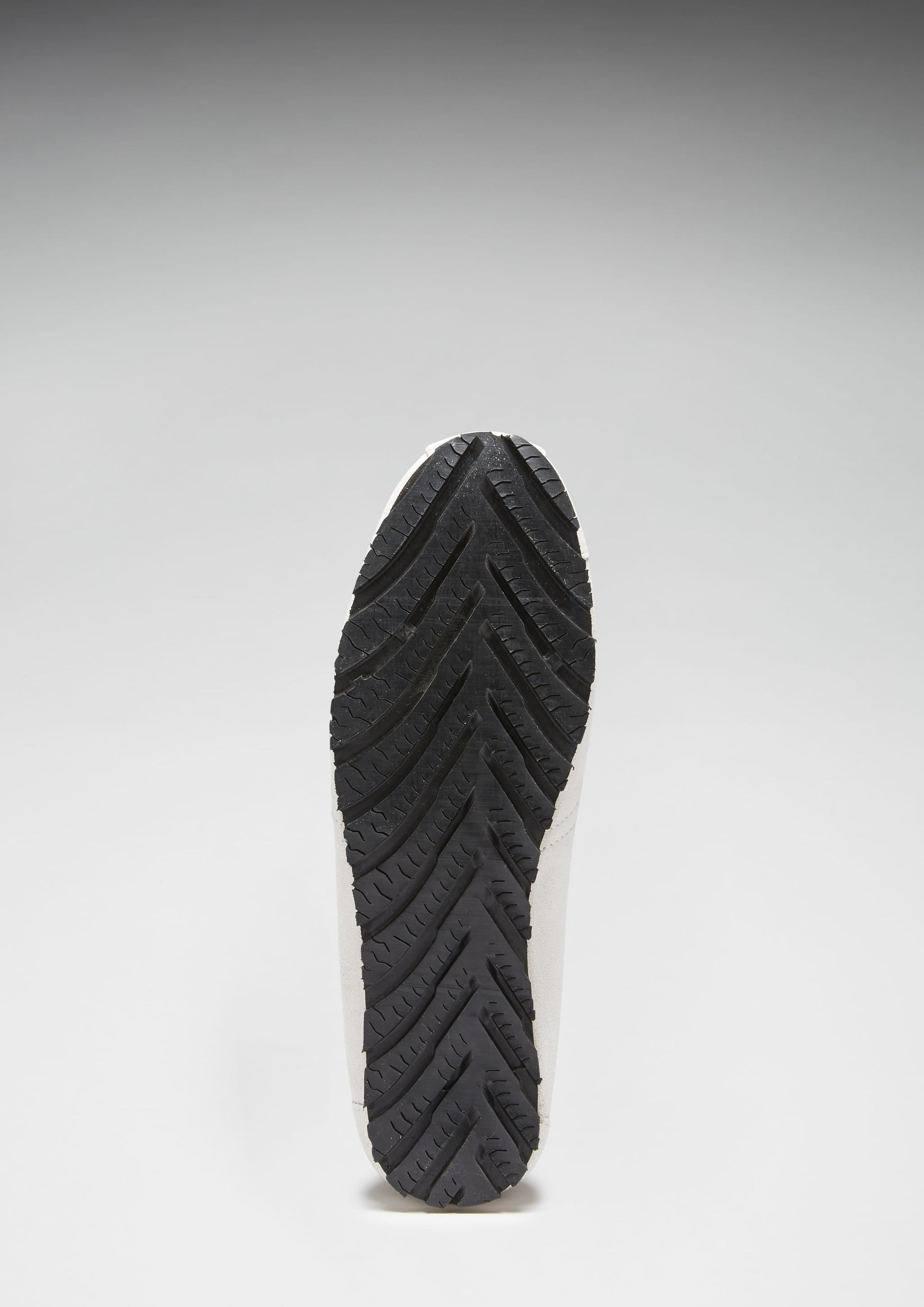 Black shoe sole on a light gray background