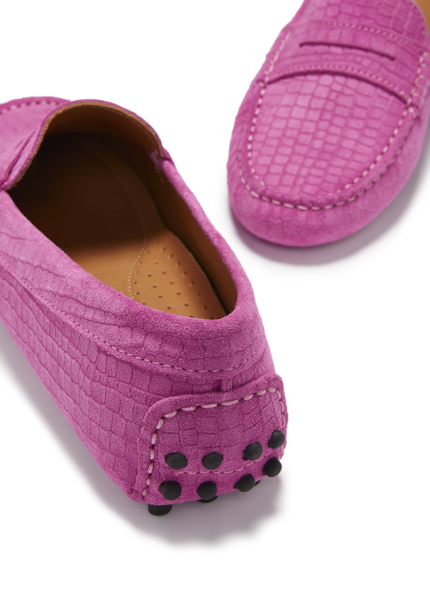 Pair of pink loafers with a textured pattern on a white background