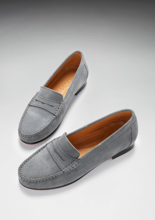 Pair of gray loafers on a light gray background