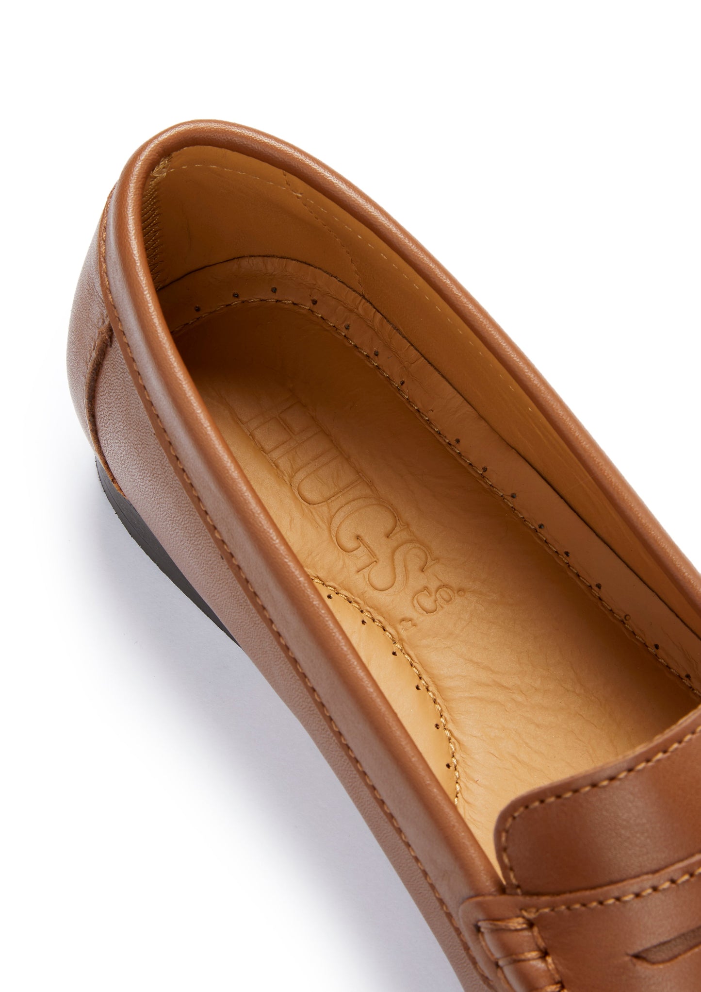 Brown loafer shoe with 'HUGS' branding on a white background