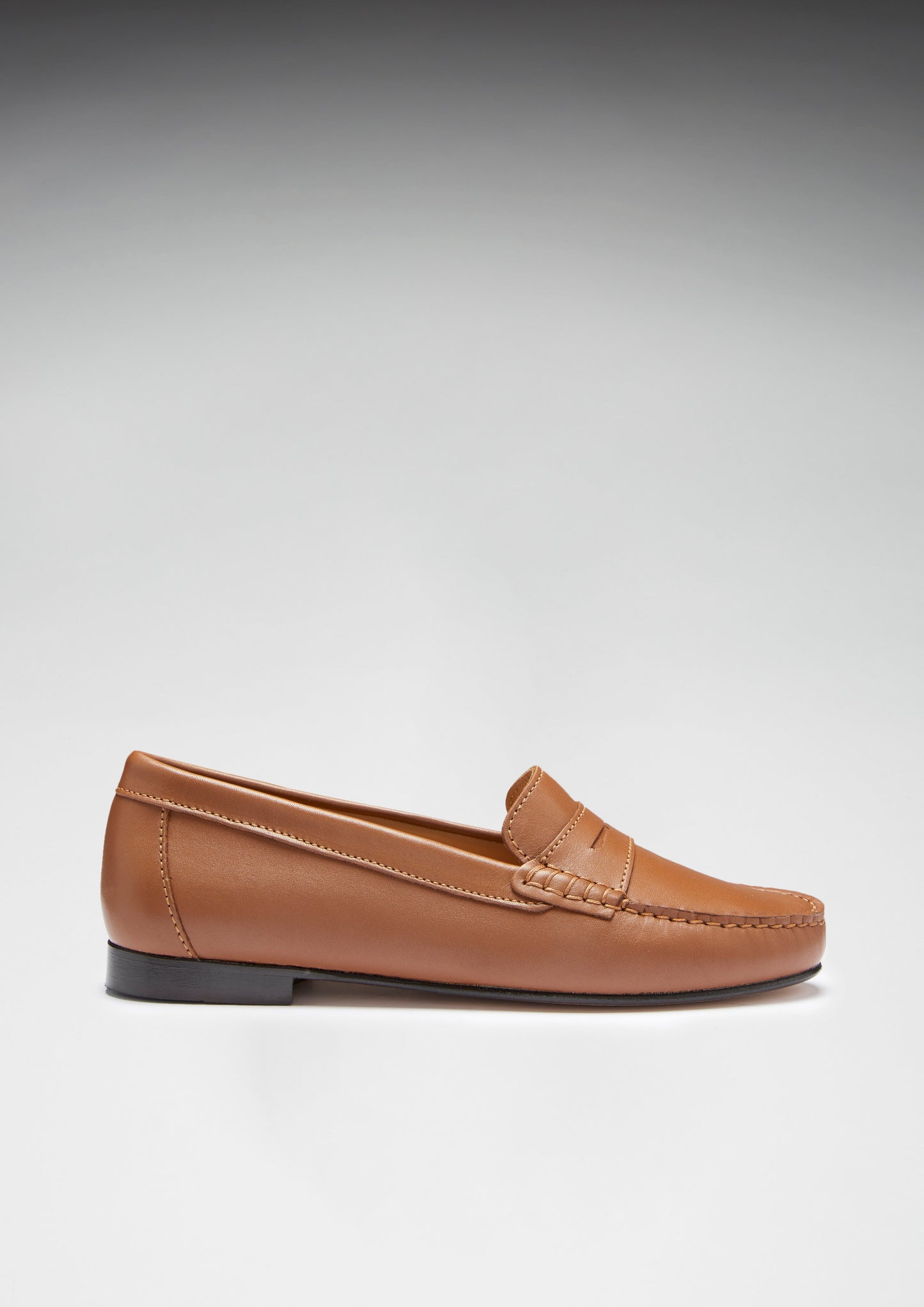 Brown loafer shoe on a gray background