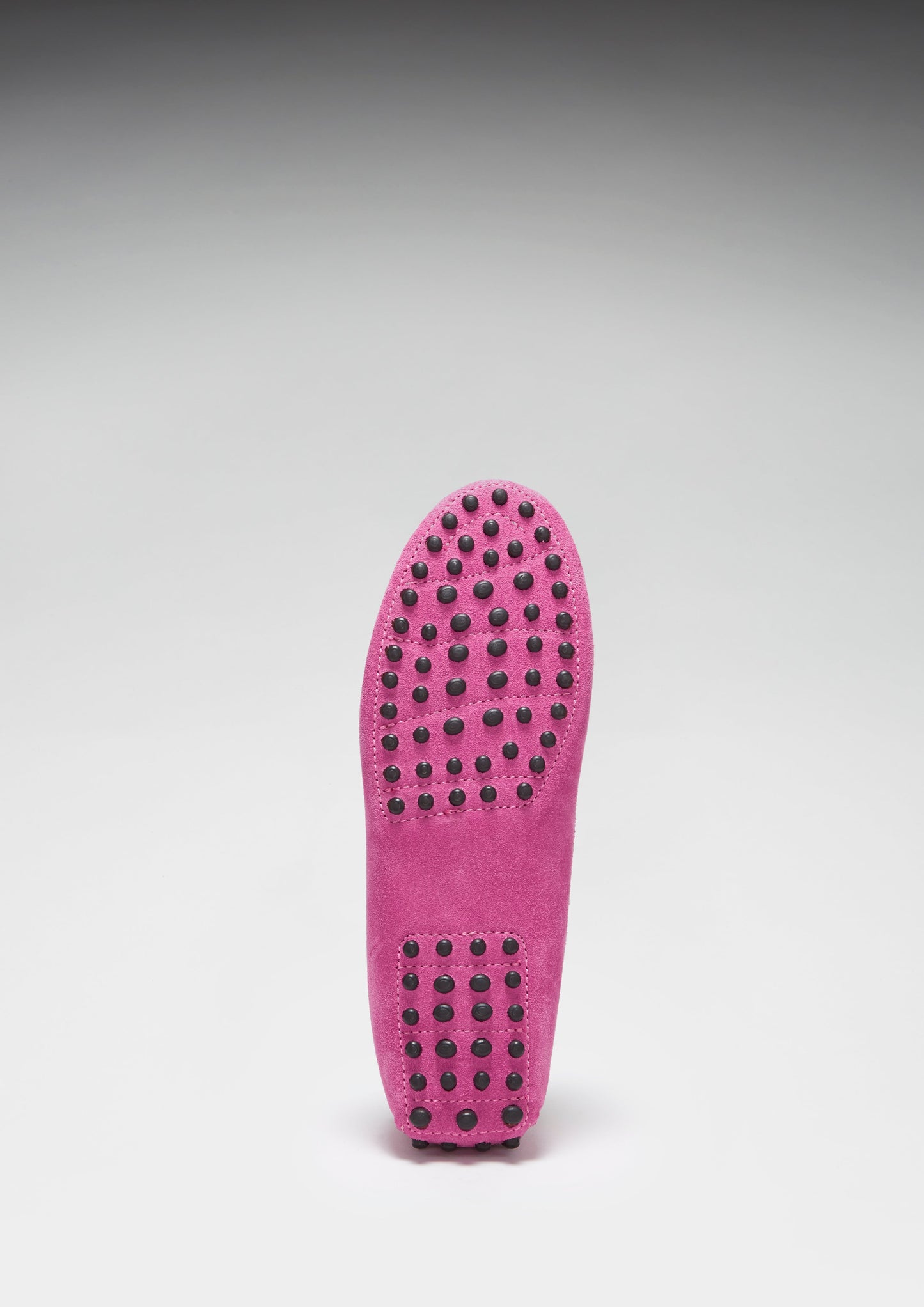 Pink shoe sole with textured pattern on a gray background