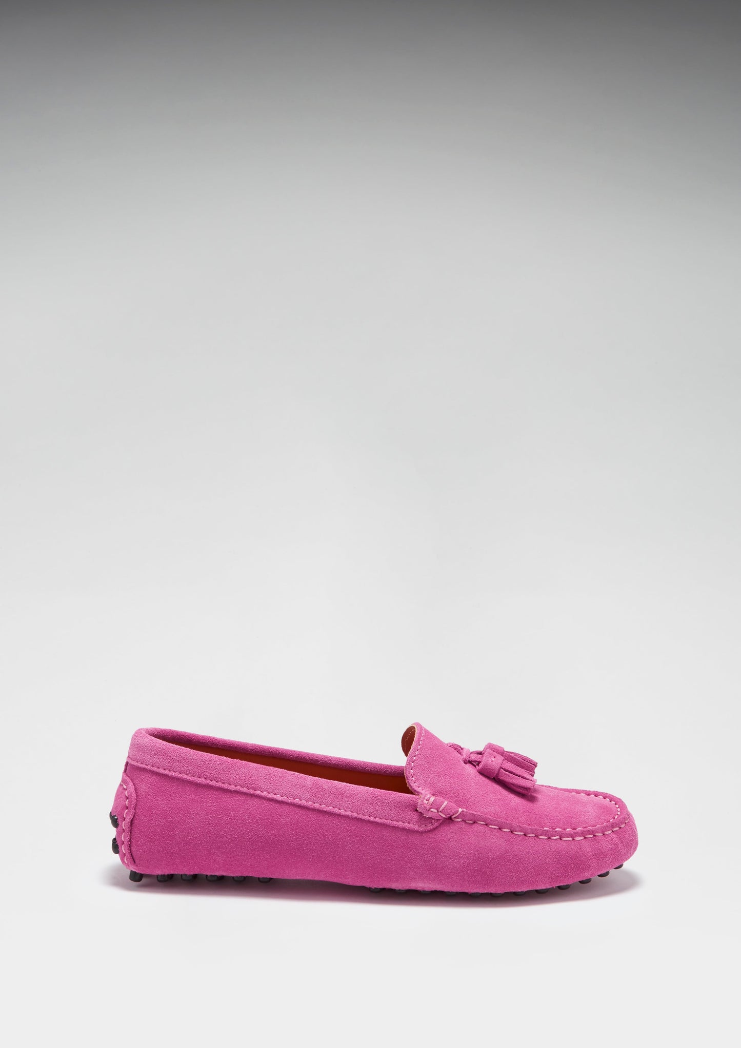 Pink loafer shoe on a light gray background