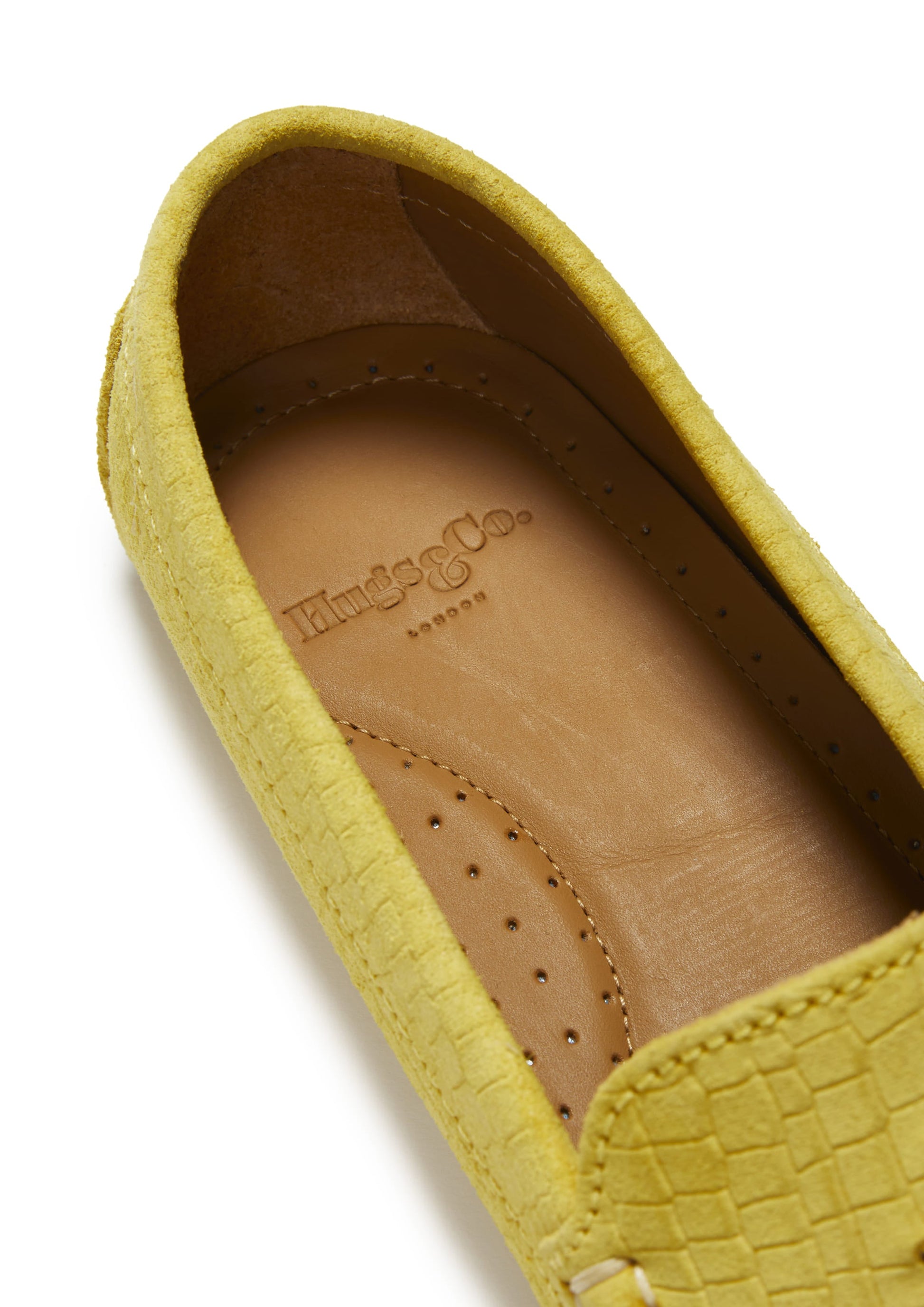 Yellow loafer shoe with branding on a white background