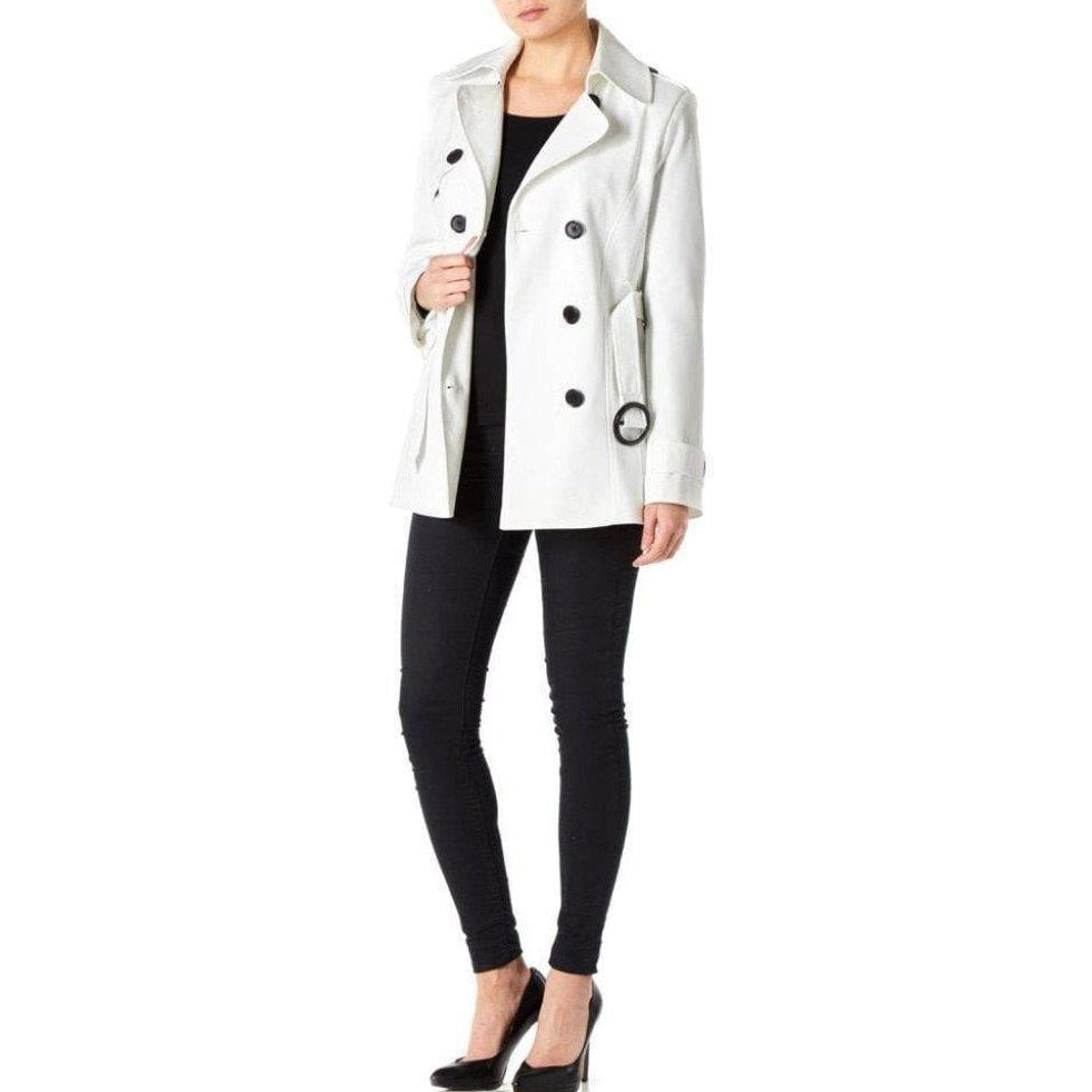Person wearing a white coat with black buttons on a white background