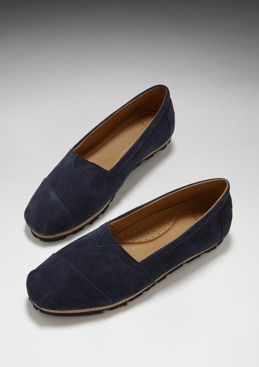 Pair of navy blue loafers on a light gray background