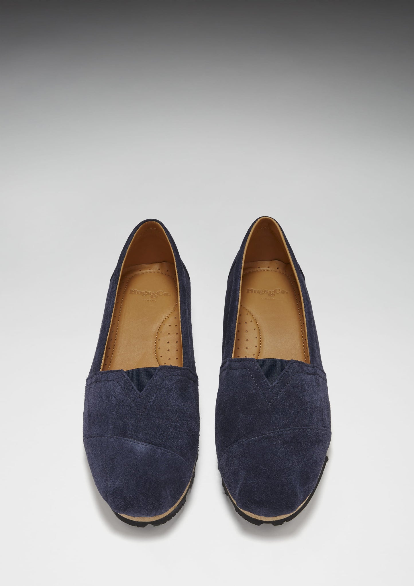 Pair of navy blue suede shoes on a light gray background