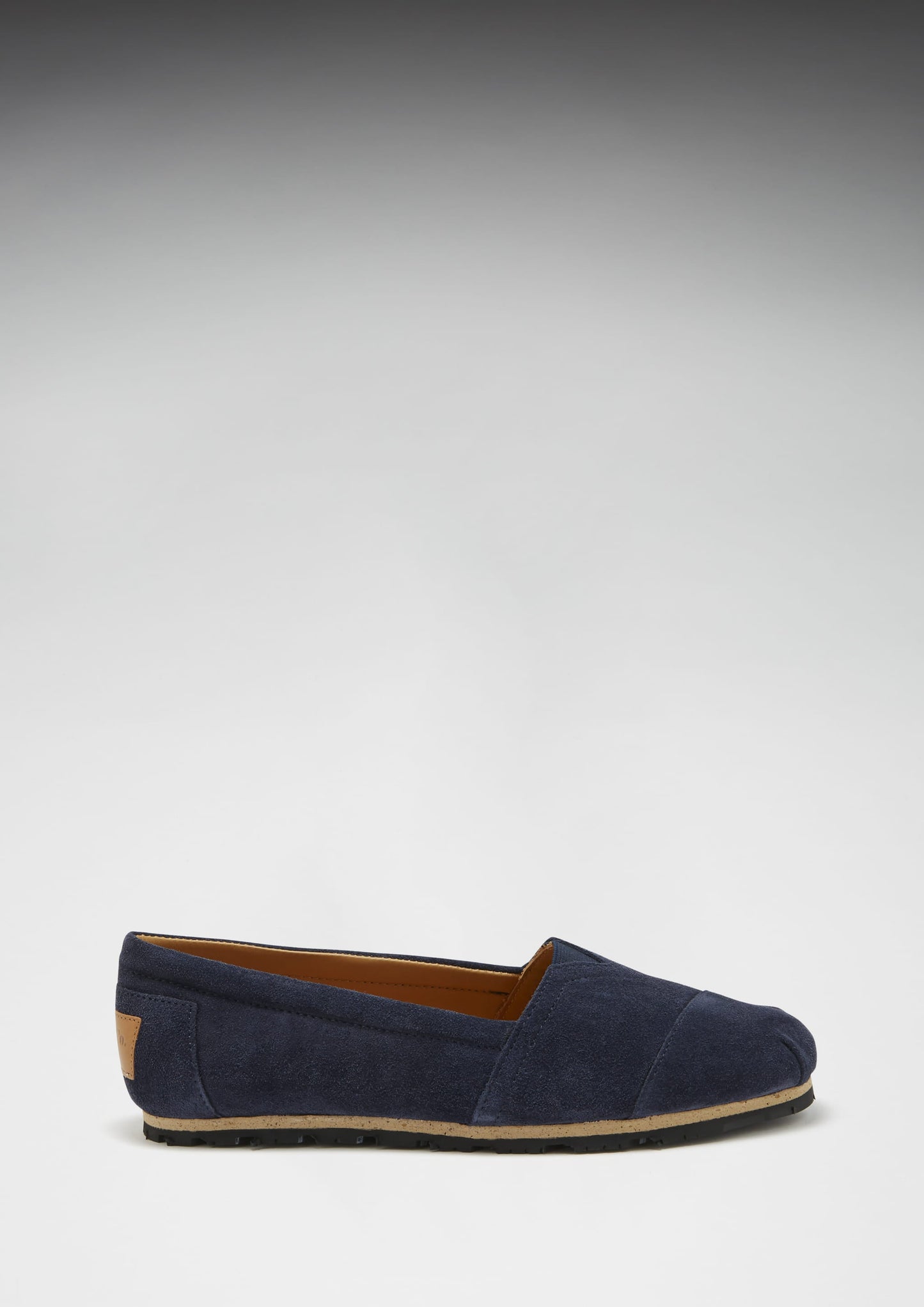 Navy blue loafer shoe on a light gray background