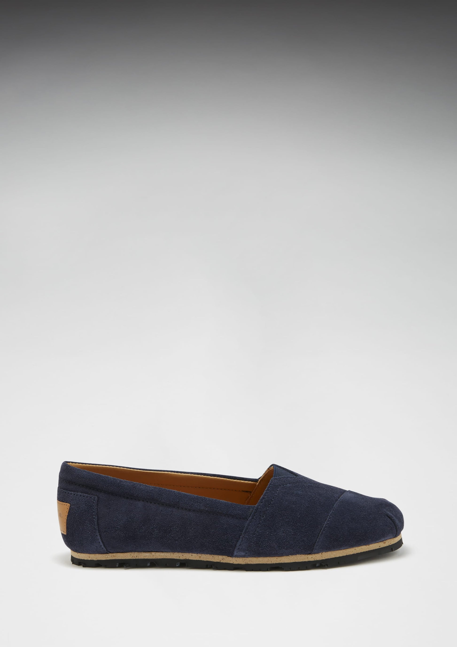 Navy blue loafer shoe on a light gray background