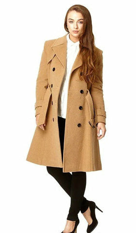 Woman wearing a beige trench coat on a white background