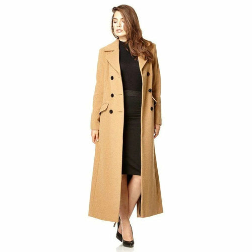 Woman wearing a long beige coat on a white background