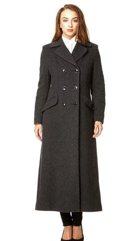 Woman wearing a long gray coat with a white shirt underneath, on a white background.