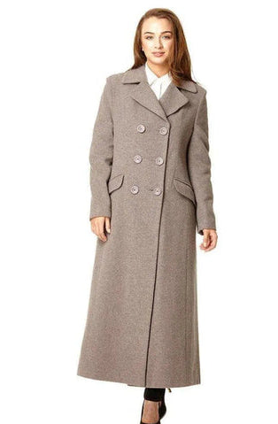 Woman wearing a long gray coat on a white background