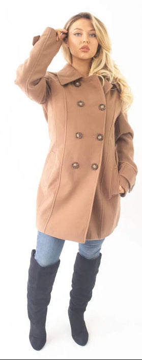 Woman wearing a tan coat on a white background