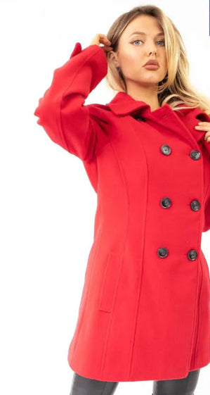 Woman wearing a red coat with black buttons on a white background