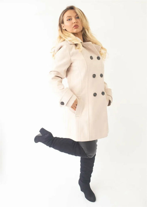 Woman wearing a beige coat on a white background
