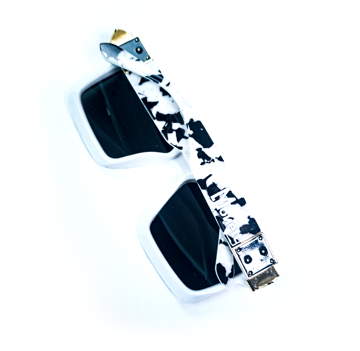 Sunglasses with a cow print strap on a white background